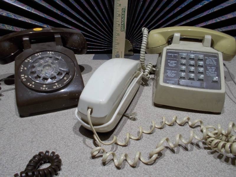 lot 110 image: The image features a collection of vintage telephones