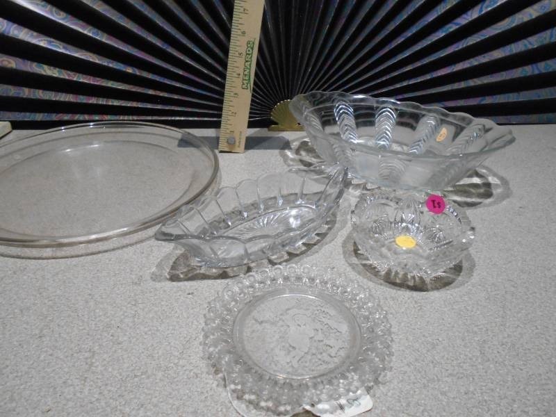 lot 164 image: This is a collection of vintage or antique clear glass dishes