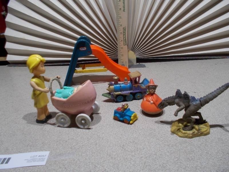 lot 257 image: This image features a collection of various vintage and small toy figures