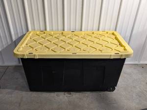 lot 74 image: Large Black Plastic Storage Tote with Yellow Lid and Wheels
