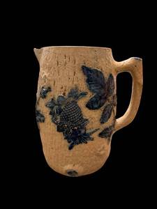 lot 95 image: Stoneware Pitcher - Floral Blue Leaves Embossed on Tan Ceramic