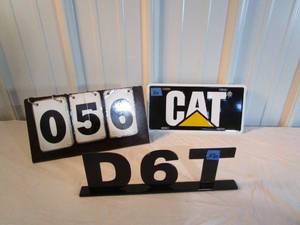 lot 56 image: Caterpillar License Plate and Heavy Metal Sign
