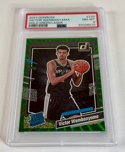 lot 28 image: Victor Vembanyama PSA 8 NM-MT RC 2023 Donruss Holo Green Laser Rated Rookie #220 Basketball Card