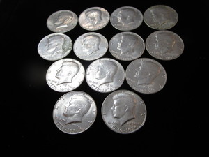 lot 63 image: Thirteen Kennedy Half Dollars