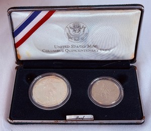lot 56 image: 1992 Columbus Quincentenary 2 coin proof set - case is fire damaged, no COA but coins appear to be in good shape