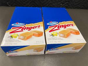 lot 149 image: Hostess Zingers Iced Vanilla Cake with Creamy Filling - 2 Boxes (6 BarsBox, 3 Packs)