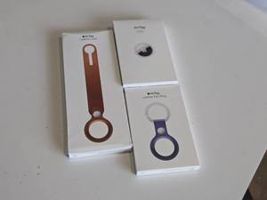 lot 24 image: Apple Air Tag 4-pack, Air Tag Leather Key Ring, Air Tag Leather Loop (in original packaging)