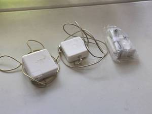 lot 59 image: Lot of (3) Apple MacBook Chargers (one new in package)