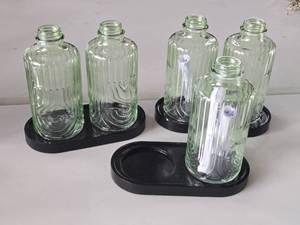 lot 182 image: Lot of (3) Black Plastic Base with (2) Green Bottles - Display Dcor