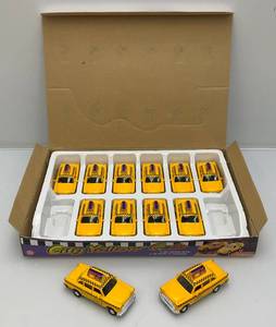 lot 72 image: New Old Stock Case Of City Yellow Cab Die Metal And Plastic Cast Taxis With Pull Back And Go Action