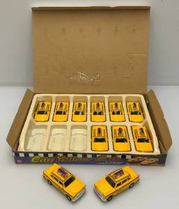 lot 153 image: New Old Stock Case Of City Yellow Cab Die Metal And Plastic Cast Metal Taxis With Pull Back And Go Action (One Cab Missing)