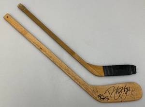 lot 231 image: Two Vintage Miniature Wooden Hockey Sticks 1Minnesota North Stars And 1 Minnesota Golden Gophers Signed With Dan Woog And More
