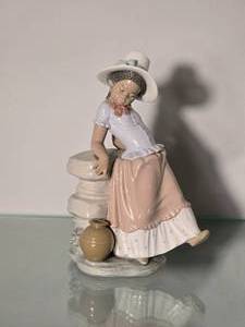 lot 133 image: Lladro Porcelain Girl Seated with Hat Figurine