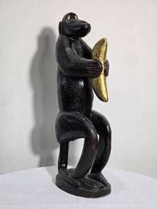 lot 139 image: Hand Carved Primitive Monkey Sculpture Holding Banana Signed