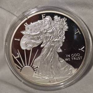 lot 53 image: 2013 Silver Eagle 100 Mills .999 Fine SIlver