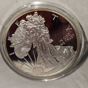 lot 49 image: 2013 Silver Eagle 100 Mills .999 Fine Silver