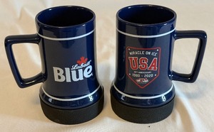 lot 52A image: (2) Miracle on Ice 40th Anniversary Labatt Blue Mugs - Team USA Hockey 1980 Olympics