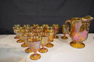 lot 263 image: Grapes & Leaves Carnival Glass Goblets with Pitcher - Iridescent Amber Set