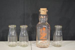 lot 102 image: Two Rivers Ice Cream Co. Glass Milk Bottles (Lot of 4) - Vintage Wisconsin