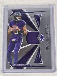 lot 82 image: Lamar Jackson 2024 Panini Phoenix Franchise Future Materials Relic #FFM-LJN and Numbered 123299 - Baltimore Ravens Football Card