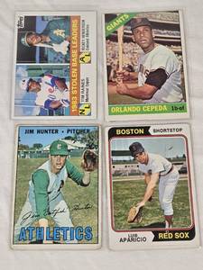 lot 120 image: Lot of 4 Vintage Baseball Cards Featuring Orlando Cepeda, Luis Aparicio, and Jim Hunter. Includes 1983 Leaders Stolen Base Leaders Card.