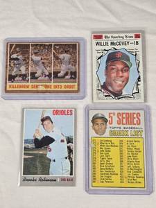 lot 124 image: Lot of 4 Vintage Baseball Cards Featuring Willie McCovey, Harmon Killebrew, and Brooks Robinson. Includes Topps Series Checklist.