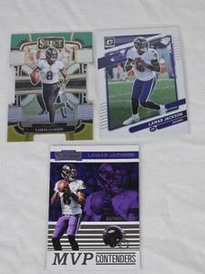 lot 196 image: Lot of 3 Lamar Jackson Football Cards including Panini Contenders MVP Contenders, Donruss Optic, and Select Prizm Concourse.