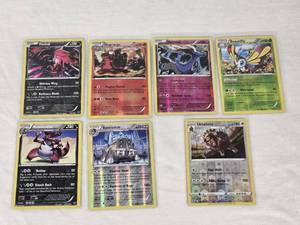 lot 357 image: Lot of 7 Pokmon Holo Cards Featuring Yveltal, Magcargo, Xerneas, Beautifly, Krookodile, Bastiodon, and Ursalunaluna with Holo Features and Mixed Types