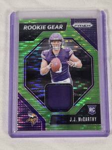lot 395 image: J.J. McCarthy Rookie 2024 Panini Prizm Green Prizm Relic #RG-JM - Minnesota Vikings Football Card