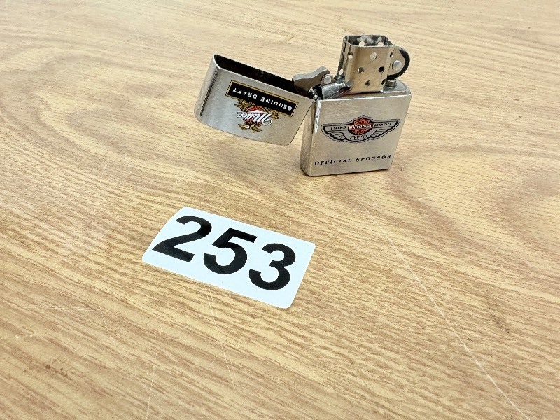 lot 253 image: Harley Davidson & MGD zippo lighter