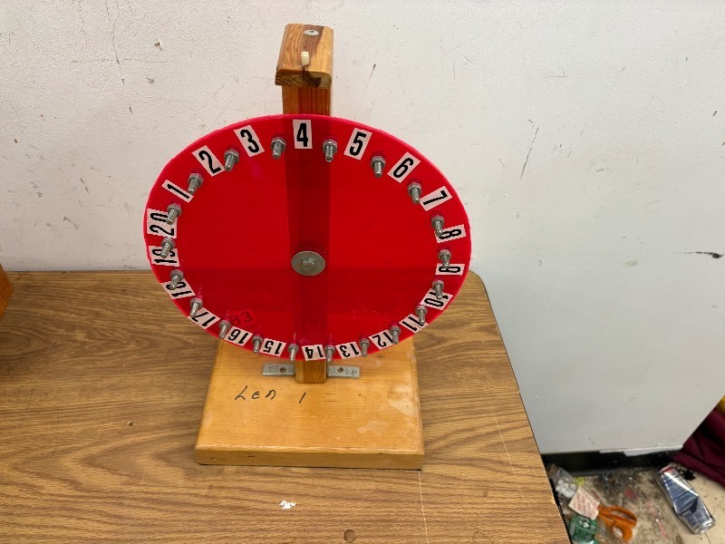 lot 283 image: Number wheel spinner on wooden base