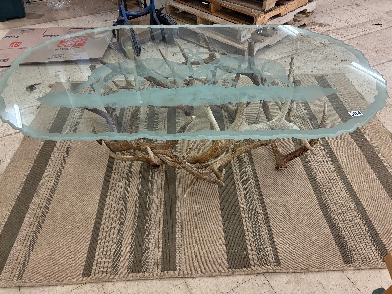 lot 304 image: Glass Top Coffee table with authentic antler base. Buck scene etching on top