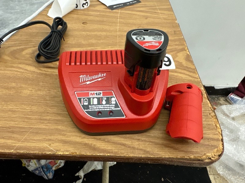 lot 339 image: Milwaukee recharchable auxiliary battery with charger stand