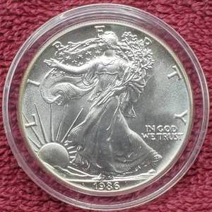 lot 7 image: 1986 American Silver Eagle in Airtite--First Year of Issue