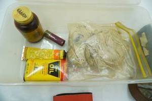 lot 19 image: Gun Cleaning supplies, Belt Buckle , hats