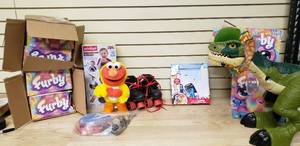 lot 57 image: Bunch of toys, Furbys, roller skates, fun mic, ping pong paddles, kids smart phone set, animated dinosaur no arms