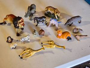 lot 54 image: Toy animal figures including a lion, elephant, tiger, giraffes, and more