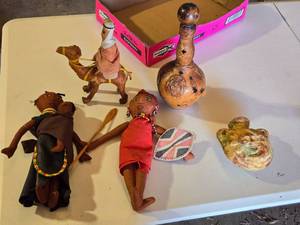 lot 57 image: Handcrafted Dolls and Decor Items including Camel Rider Figurine and Leather Covered Glass Bottle