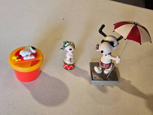 lot 63 image: Snoopy Figurines Collection including Fun in the Sun Snoopy Statue, Drum Ornament, and Snoopy in Pool Toy