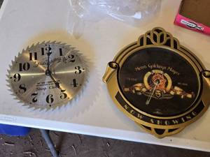 lot 100 image: Sears Roebuck Saw Blade Wall Clock and MGM Now Showing Wall Clock