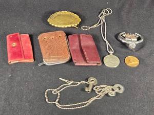 lot 342 image: Assorted Vintage Collectibles including Liberty Bell Belt Buckle, Cadillac Emblem, and Leather Key Pouches