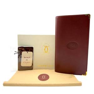 lot 67 image: Cartier Les Must de Cartier Burgundy Leather Wallet with Original Packaging Pre-Owned Retail $650