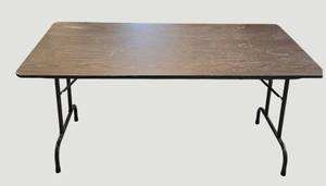 lot 91 image: Stylish table with a wood-like surface and metal legs, measuring 59.5 x 30 inches.