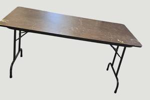 lot 92 image: Stylish black table with a sturdy wood-like surface and chic metal legs, measuring 59.5 x 30 inches.