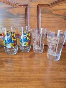 lot 18 image: 2 Coke Glasses, 2 Vintage Handy Smurf Glasses