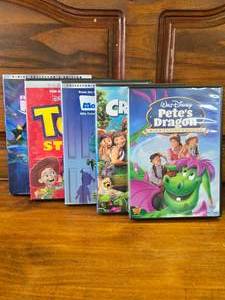 lot 57 image: 5 kids DVDs Petes Dragon, Croods, Monsters Inc, Toy Story, Finding Nemo