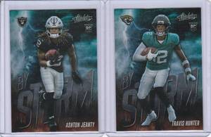 lot 81 image: 2025 Panini Absolute By Storm Rookies - Travis Hunter #17, Ashton Jeanty #1
