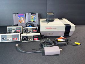 lot 68 image: Nintendo NES-001 Entertainment System with 4 Controllers, 2 Cartridges, AV Cables & RF Modulator
