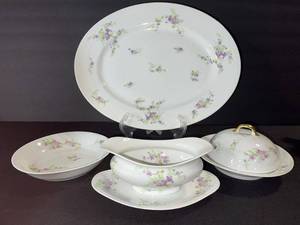 lot 93 image: Limoges L. Bernardet & Cie Lilac Floral Dinnerware Set with Covered Sugar & Gravy Boat