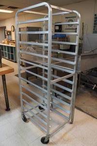 lot 49 image: Industrial Stainless Steel Baking Tray Rolling Rack - Missing Wheel